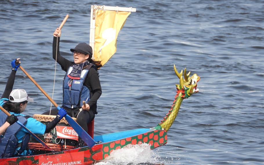 A woman leading a dragon boat.